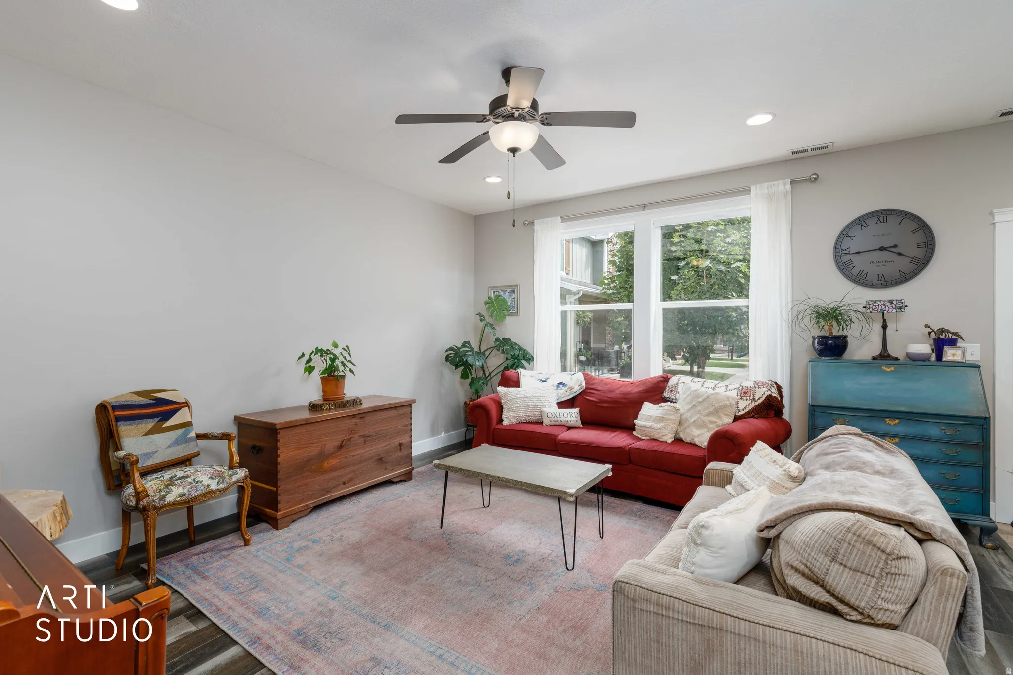 Recessed lighting, ceiling fan with integrated light, large windows, and dark wood-finish flooring