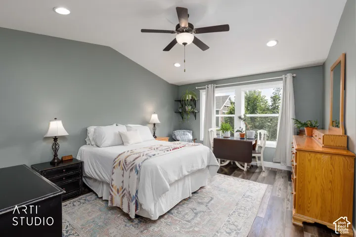 Primary bedroom suite featuring soft sage-green walls, recessed ceiling lighting, and a ceiling fan with integrated light fixture
