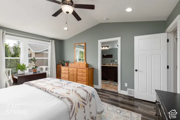 Vaulted ceiling with a ceiling fan, recessed lighting, wood-finish flooring, and a panel door