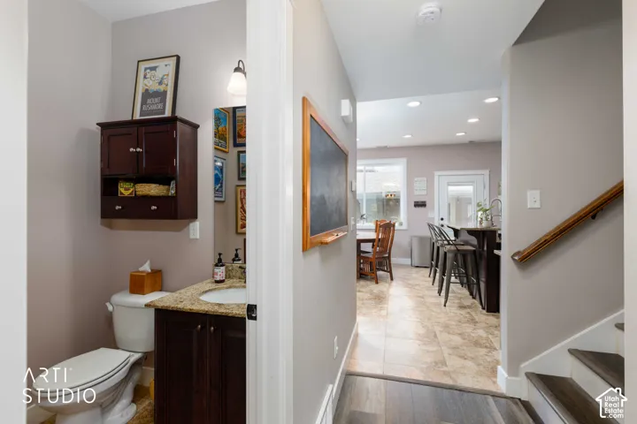 Powder room with vanity and wall-mounted storage cabinet