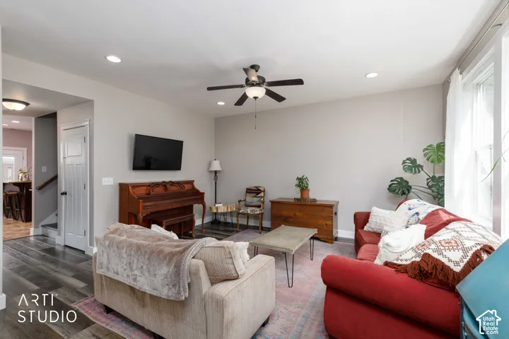 Living area with wood-finish flooring, recessed lighting, and a ceiling fan