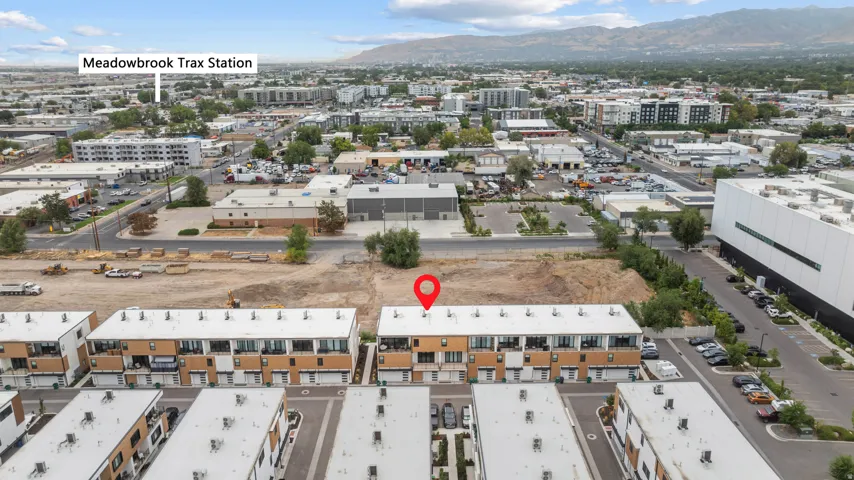 Aerial perspective of multi-level townhomes with flat roofs and integrated garages