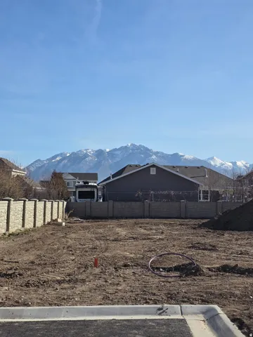 Cleared lot with a concrete perimeter, featuring a block wall boundary