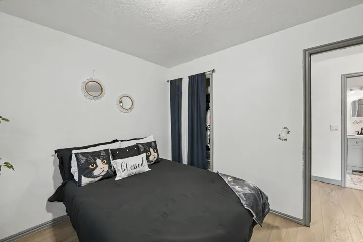 Neutral wall paint, wood-finish flooring, and a closet with bifold doors