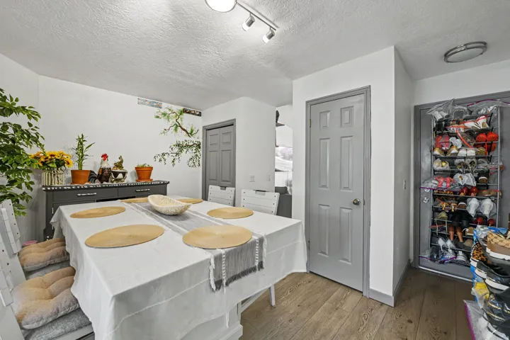 Wood-finish flooring with white walls and gray trim