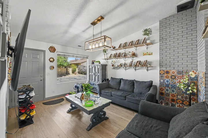 Wood-finish flooring throughout, complemented by a light gray entry door
