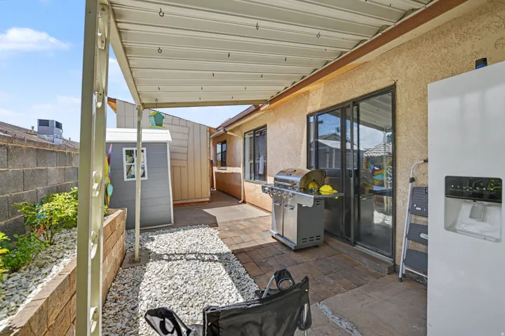 Covered patio with a metal roof and paved flooring
