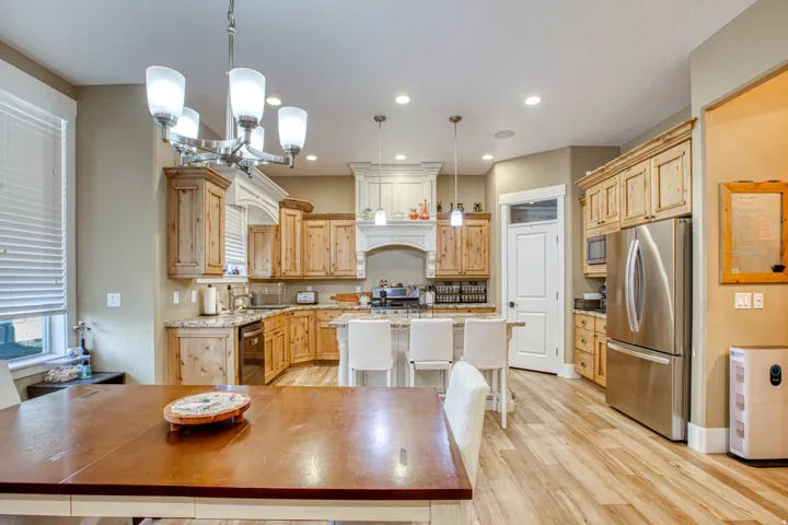 Kitchen featuring wood-finish flooring, recessed lighting, and a chandelier with frosted glass shades