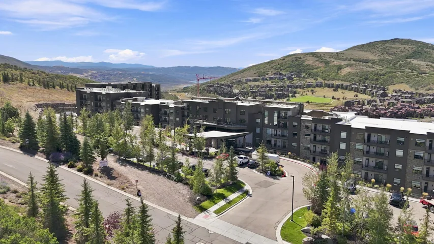 Contemporary multi-story building featuring multiple balconies and a covered entry