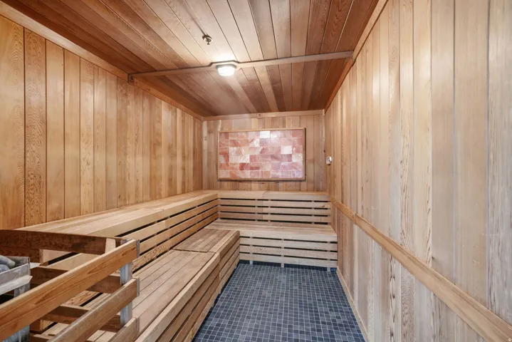 Wood-paneled walls and ceiling with multi-tiered wood bench seating