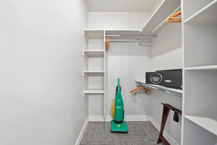 Dedicated closet space featuring floor-to-ceiling wire shelving, multiple hanging rods, and built-in storage cubbies