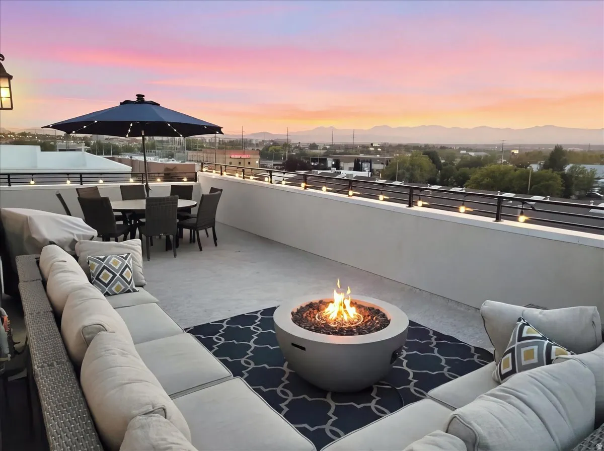 Rooftop deck featuring a fire pit, string lights, and a full perimeter railing