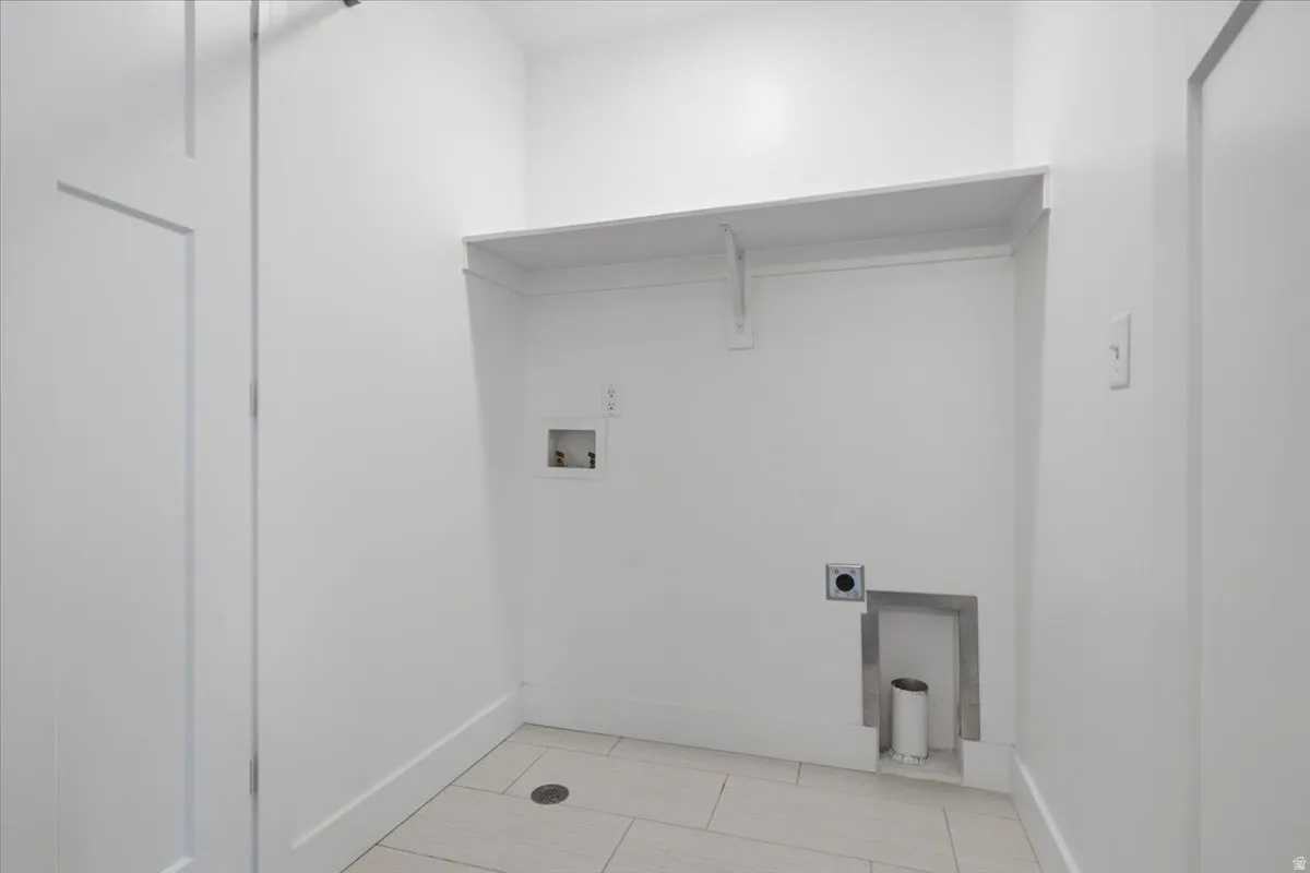 Built-in shelving, white walls, and light-toned tile flooring
