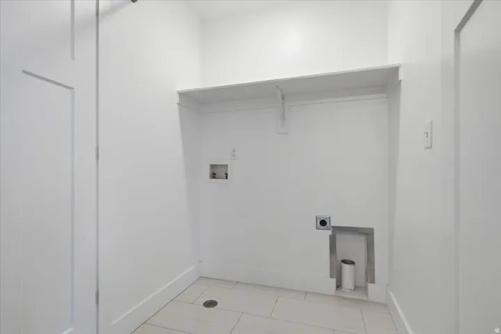 Built-in shelving, white walls, and light-toned tile flooring
