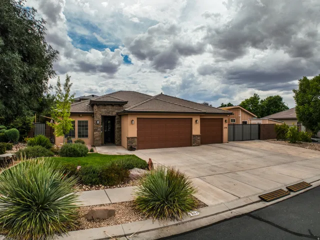 Stucco exterior with stone accents and a tile roof