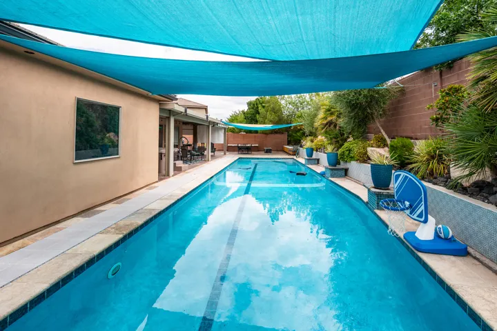 Expansive outdoor swimming pool with a surrounding paved deck