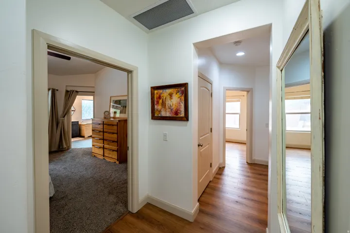 Wood-finish flooring and recessed lighting in the hallway