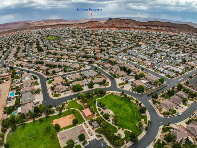 Residential neighborhood with a community park and distant mountainous terrain