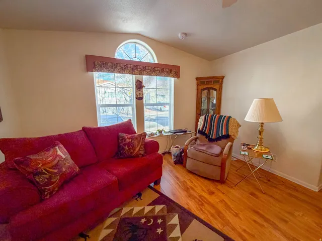 Vaulted ceiling, arched transom window, wood-finish flooring, corner built-in display cabinet