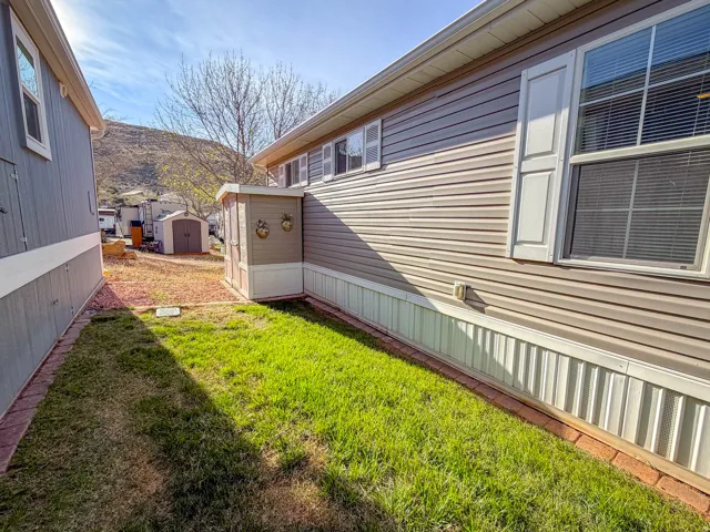 Exterior siding and white-paneled window shutters