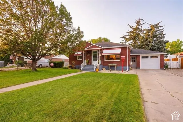 Charming red brick residence set on a lush, manicured lawn with mature landscaping