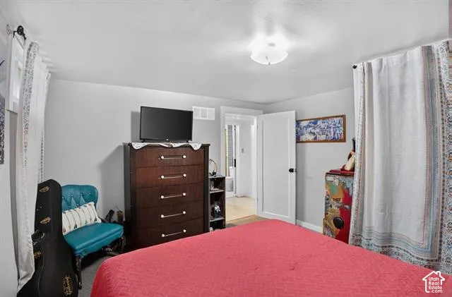 Neutral wall paint, ceiling-mounted light fixture, and wood-finish door