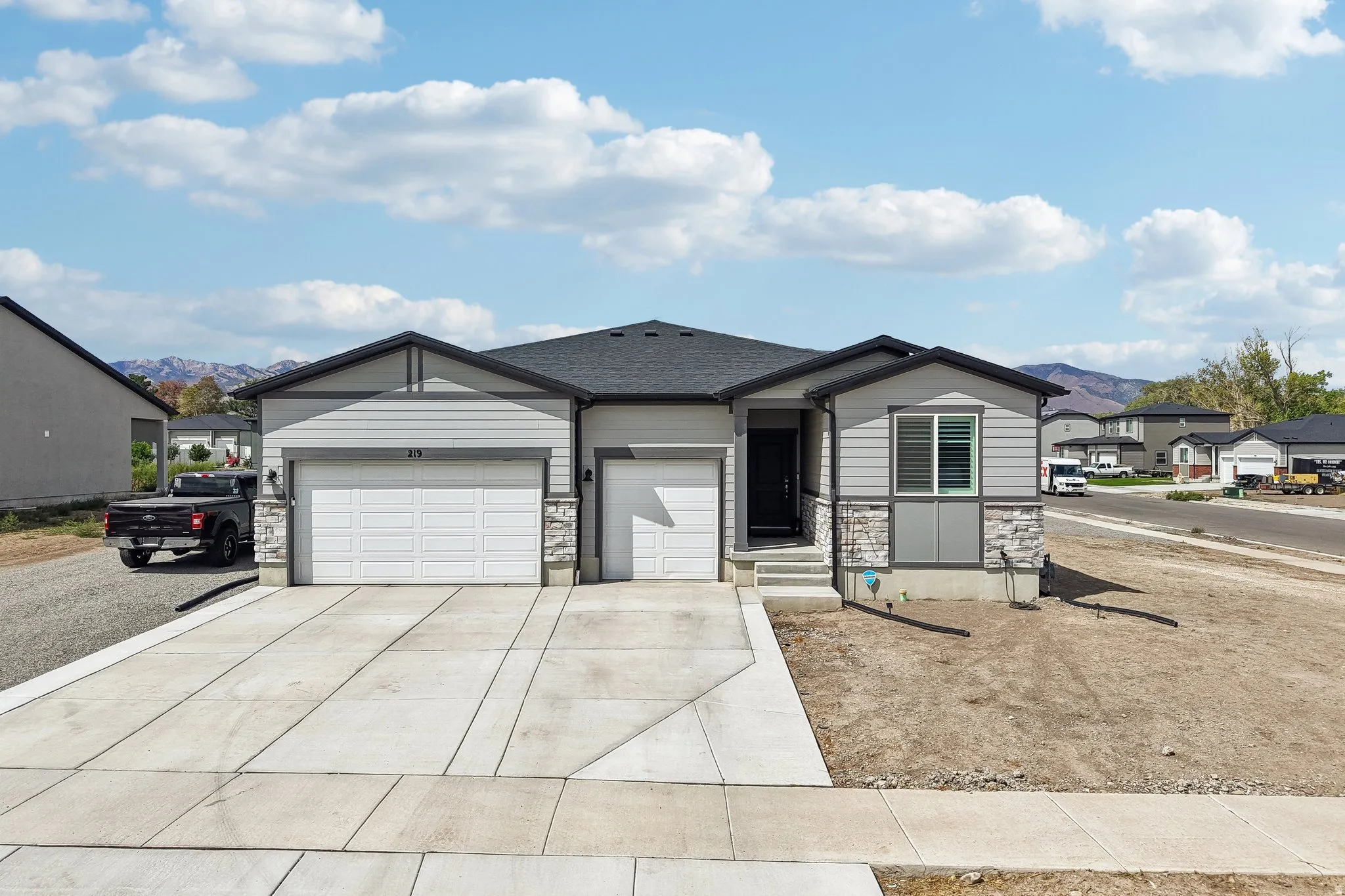 Modern exterior with gray siding and stone accents