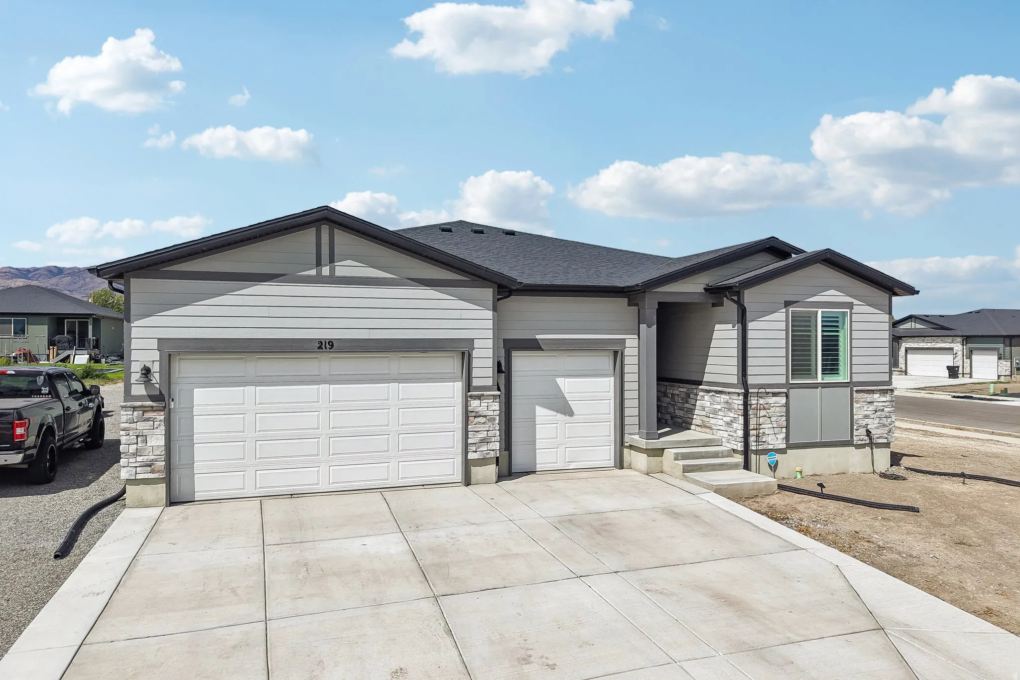 Contemporary ranch-style exterior with siding and stone accents
