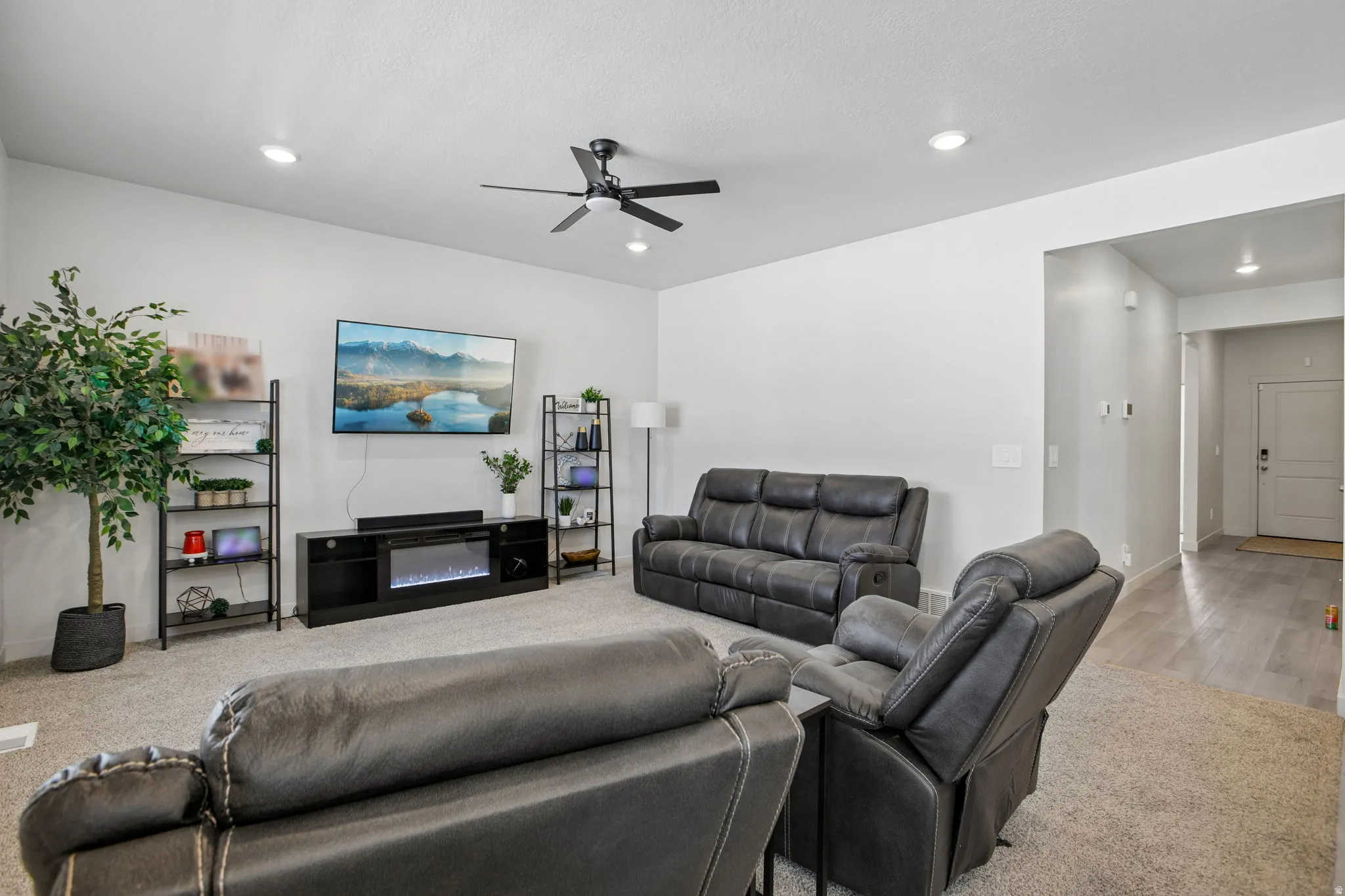 Recessed ceiling lighting, ceiling fan, and carpeted flooring