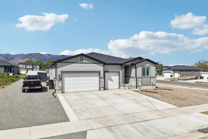 Contemporary exterior featuring gray siding and stone accents
