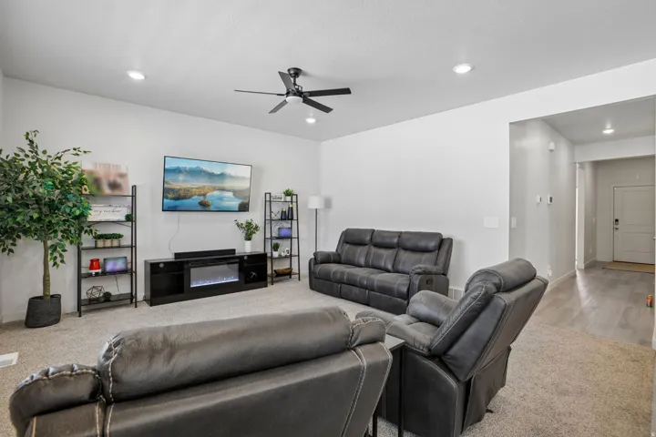 Recessed ceiling lighting, ceiling fan, and carpeted flooring