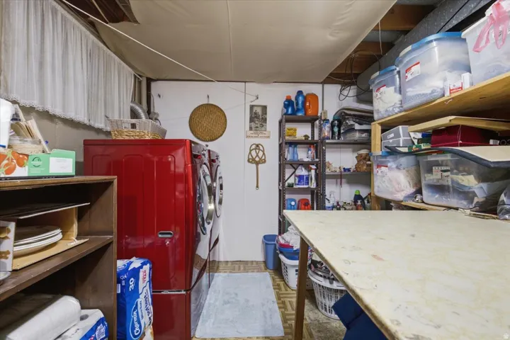 Utility room featuring a washer and dryer, built-in shelving, and a workspace
