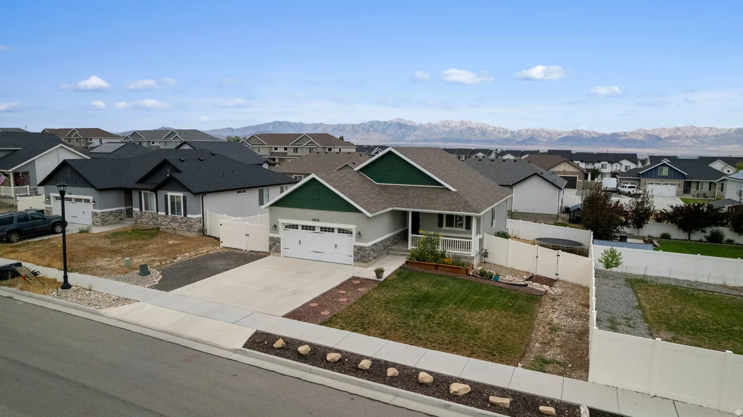 Modern ranch-style exterior with stone accents and a covered front porch