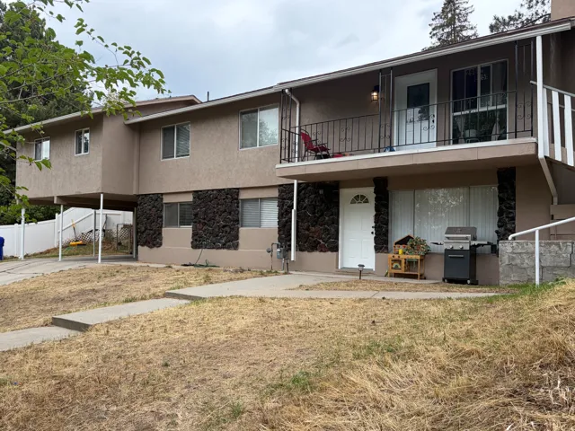 Multi-level exterior with stucco finish and stone accents