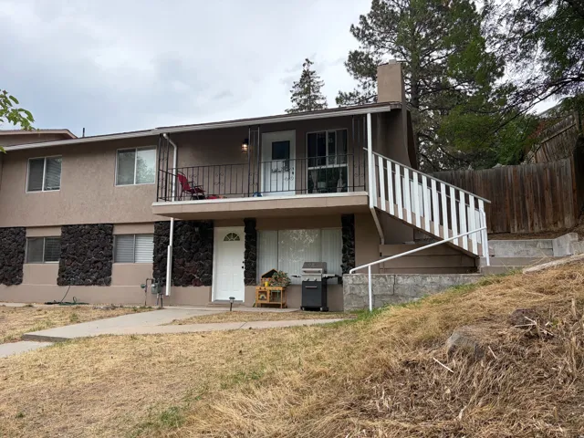 Two-story exterior with stucco siding and stone detailing