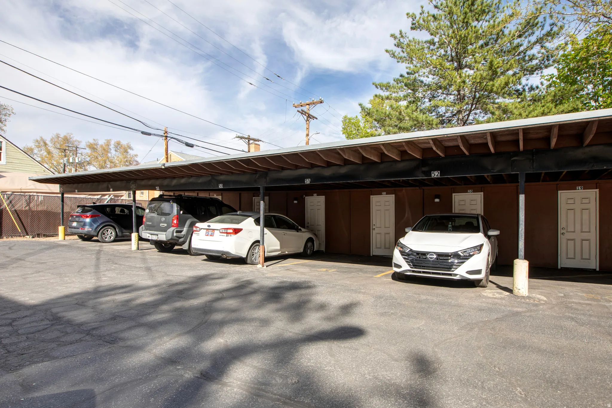 Carport parking with multiple covered spaces and direct access to entries