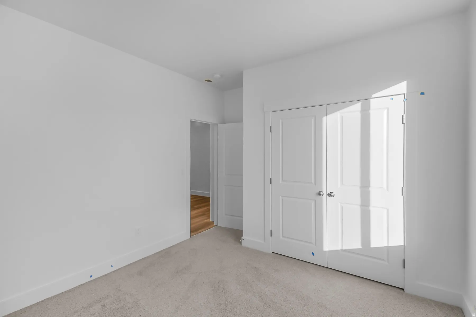 Neutral wall color, carpet flooring, paneled bifold doors, and a recessed light fixture