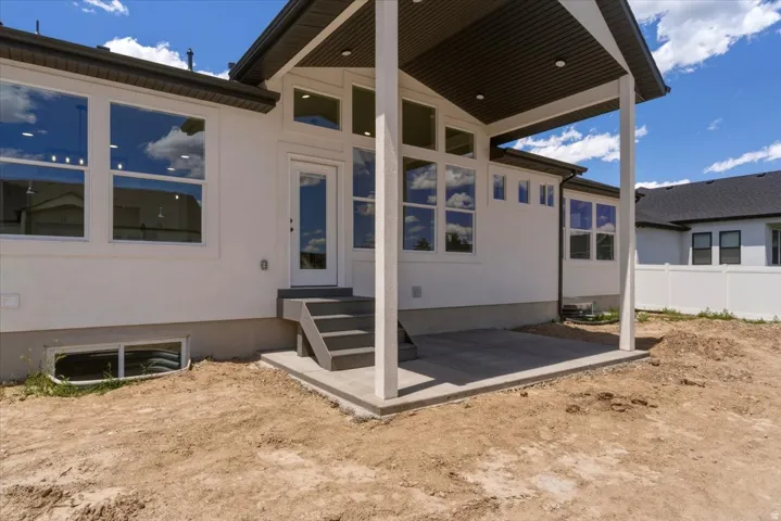 Covered patio with recessed lighting, steps, and a glass-paneled exterior door