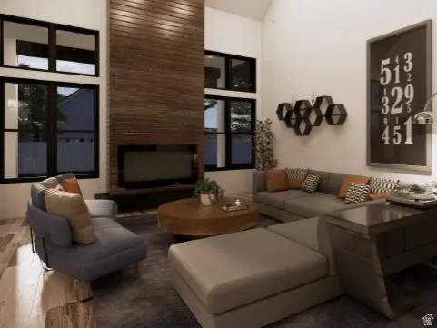 Vaulted ceiling living area featuring a wood-panel accent wall, integrated fireplace, and expansive black-framed windows