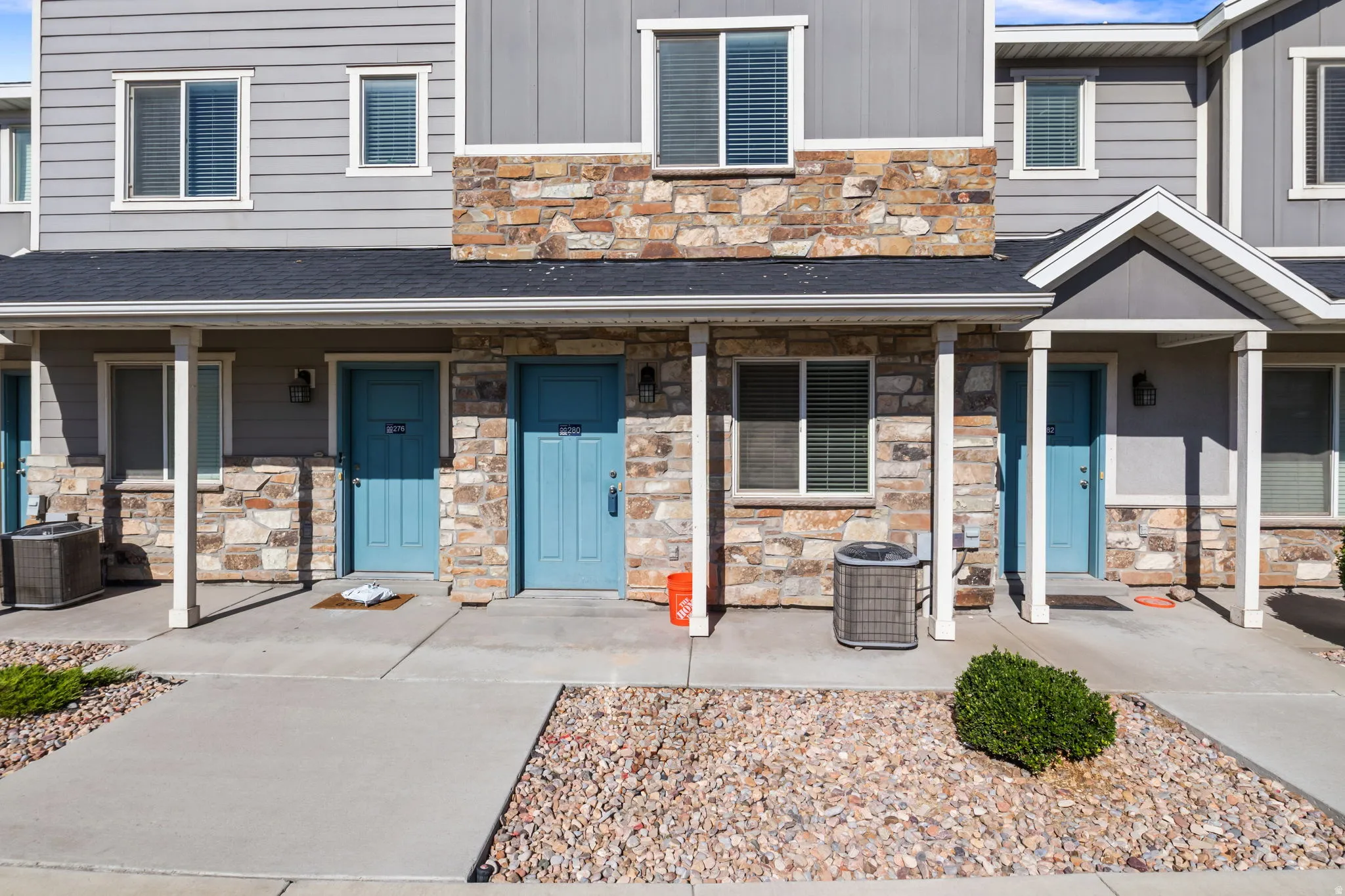 Multi-level exterior featuring stone veneer and horizontal siding