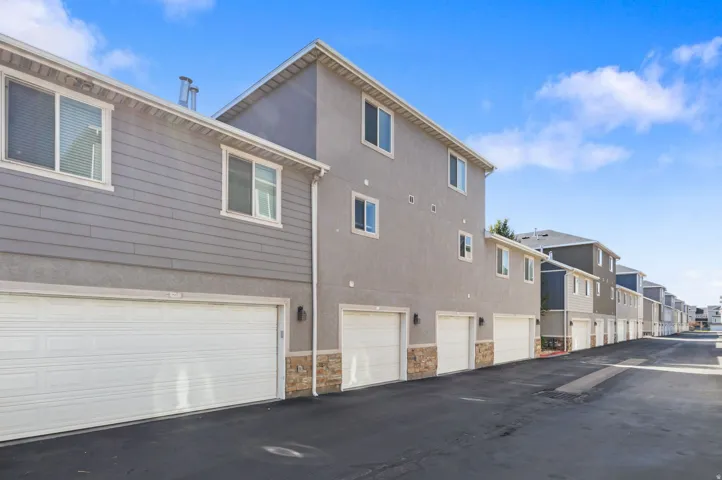 Multi-story exterior with a mix of horizontal siding and stucco finishes