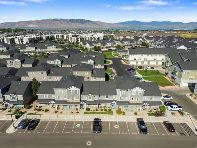Townhome community featuring multi-level residences, dedicated parking, mature landscaping, and mountain scenery