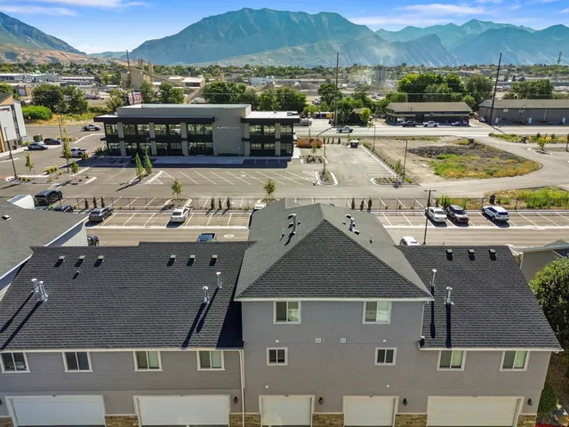 Modern townhome exterior with attached garages and shingle roofing