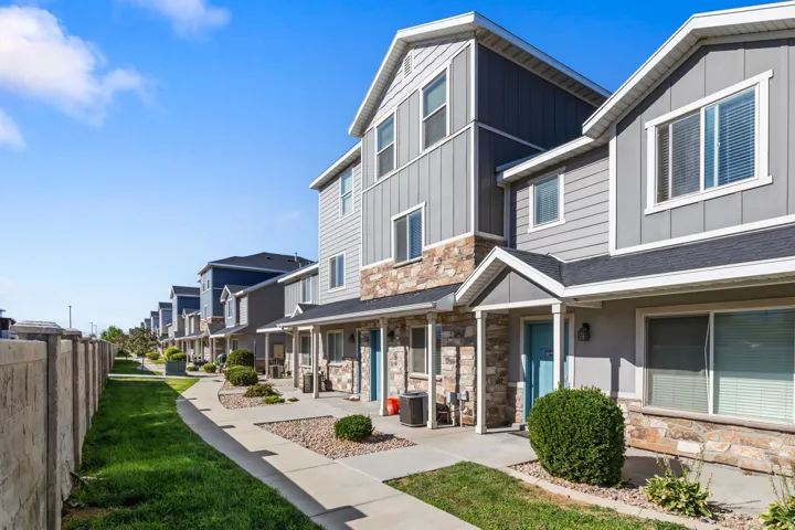 Multi-level townhome with stone veneer and horizontal siding accents