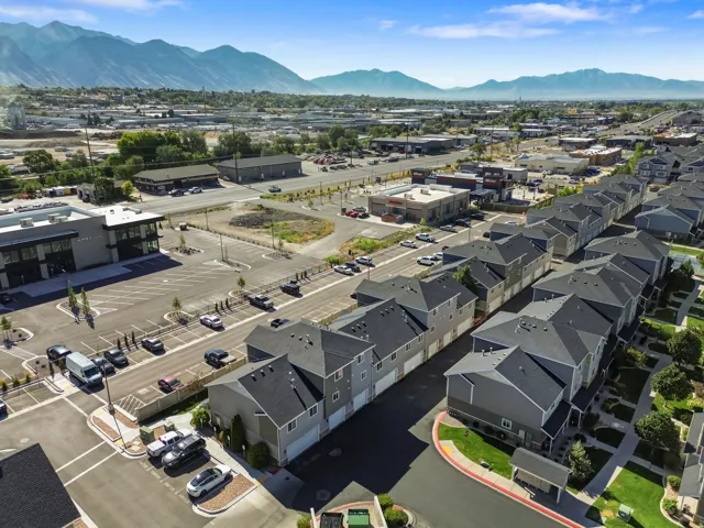Modern townhome development with pitched shingle roofs and integrated garages