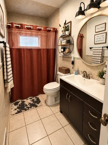 Built-in vanity with dark wood-finish cabinetry, integrated sink, and brushed nickel hardware