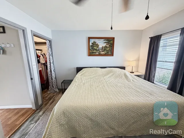Wood-finish flooring with a ceiling fan overhead