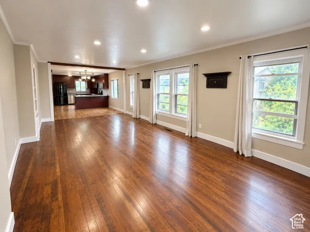 Open-concept interior featuring wood-finish flooring, recessed lighting, and expansive windows