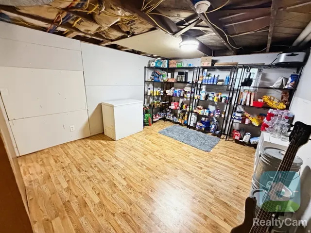 Wood-finish flooring with a ceiling-mounted light fixture