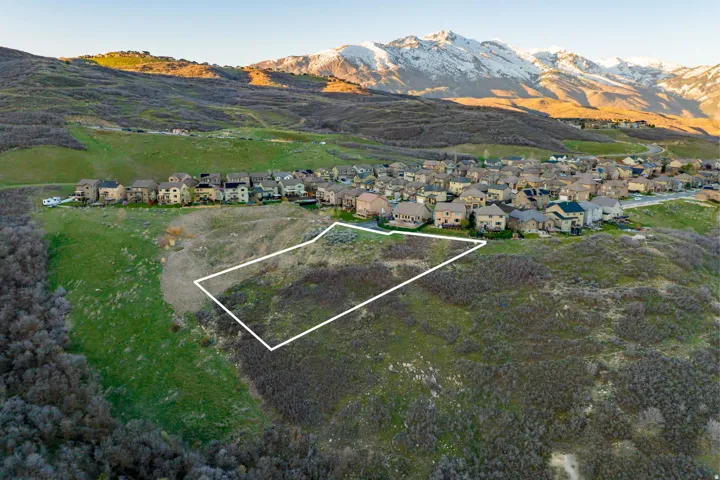 Expansive lot featuring varied topography and surrounding residential development